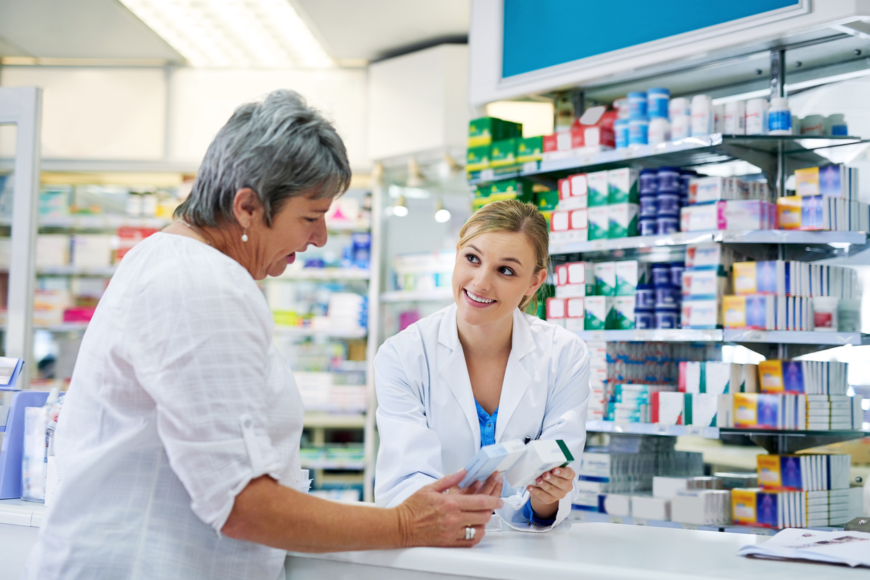Can I recommend this? Shot of a young pharmacist assisting a customer
