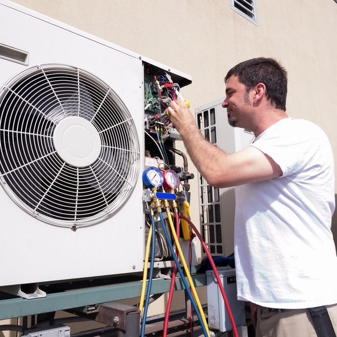 HVAC technician working on a mini-split condensing unit
